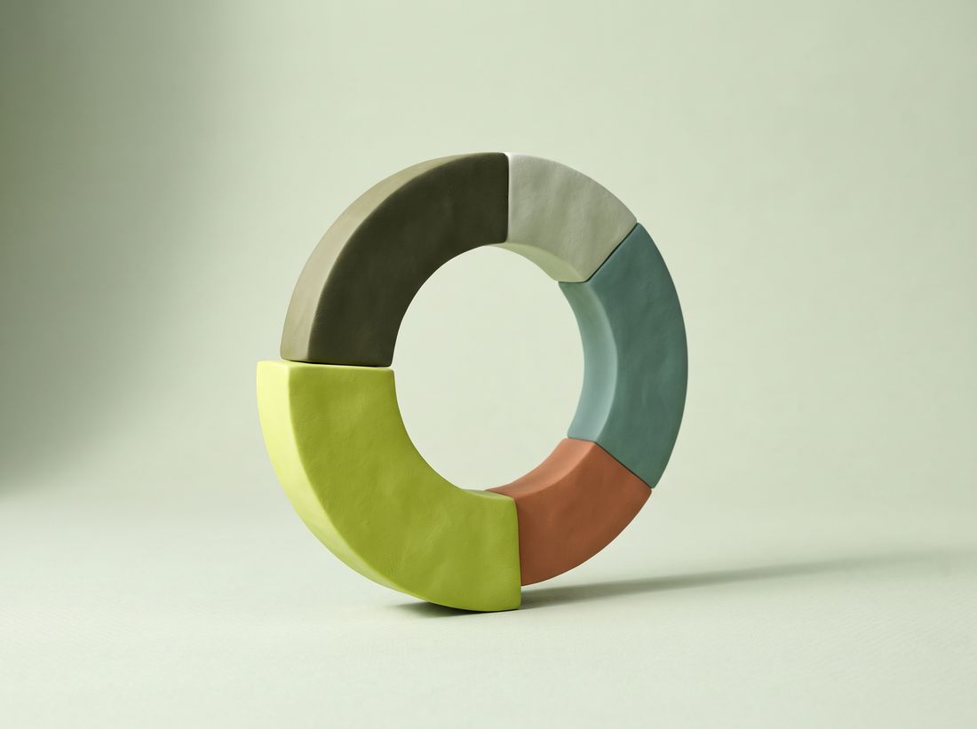 A sculpted ring divided into coloured segments